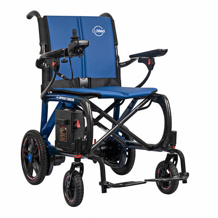 An electric motorized wheelchair with a blue padded seat and backrest, a black frame, and small wheels, shown on a plain white background. The brand 'iMed' is visible on the backrest, and 'BROOK CANVAS' is visible on the side frame.