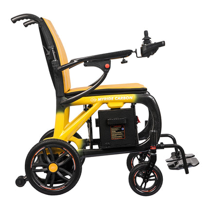 A MYRIDE CARSON electric wheelchair with a black and yellow carbon-fiber-look frame, orange-tan seat and backrest, black wheels, and a joystick control on the right armrest, shown on a plain white background.
