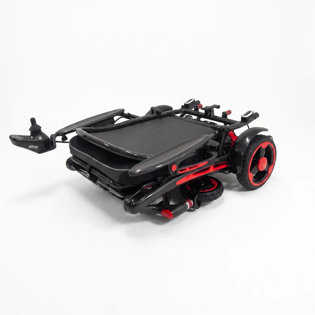 Ikon Enduro Powerlite Pro wheelchair folded for storage, on white