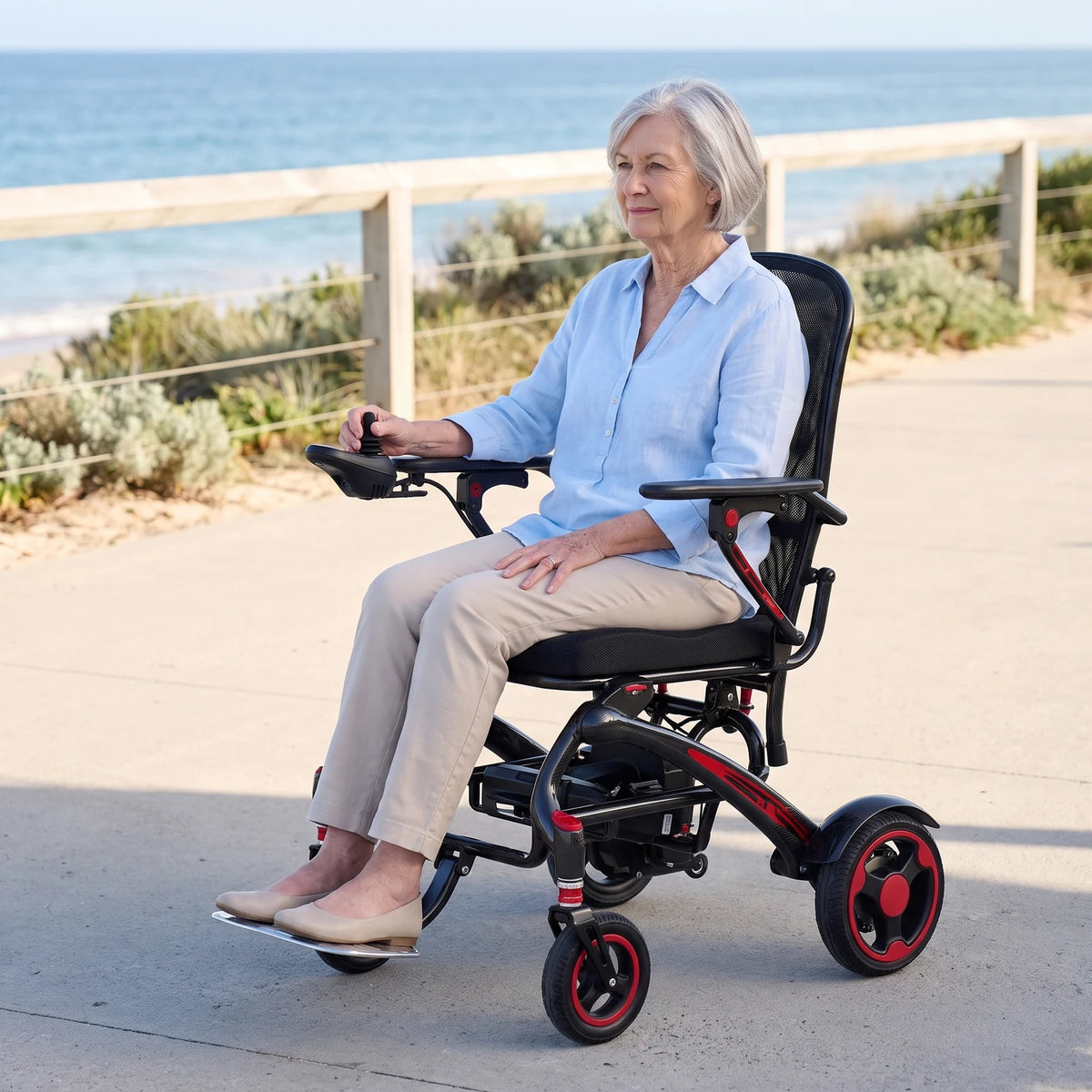 Older woman using an Ikon Enduro Powerlite Pro wheelchair on a level beach promenade