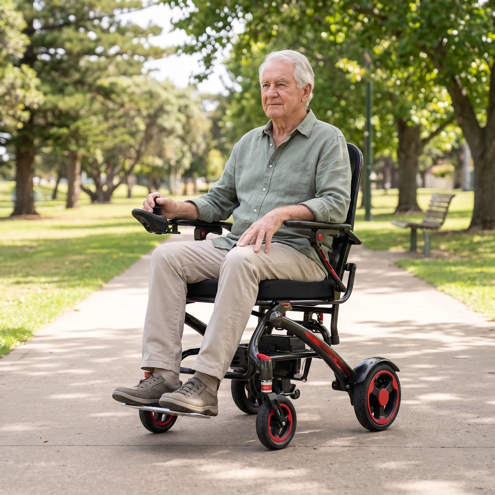 Older man using an Ikon Enduro Powerlite Pro wheelchair on a level park path